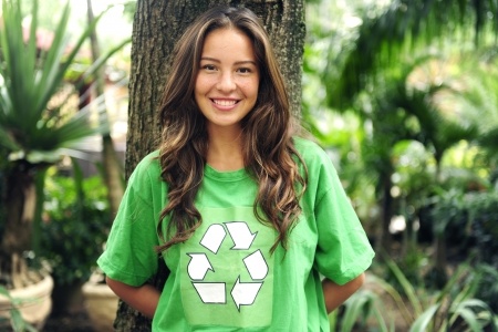 young environmental activist in the forest wearing a green recycle t-shirt
